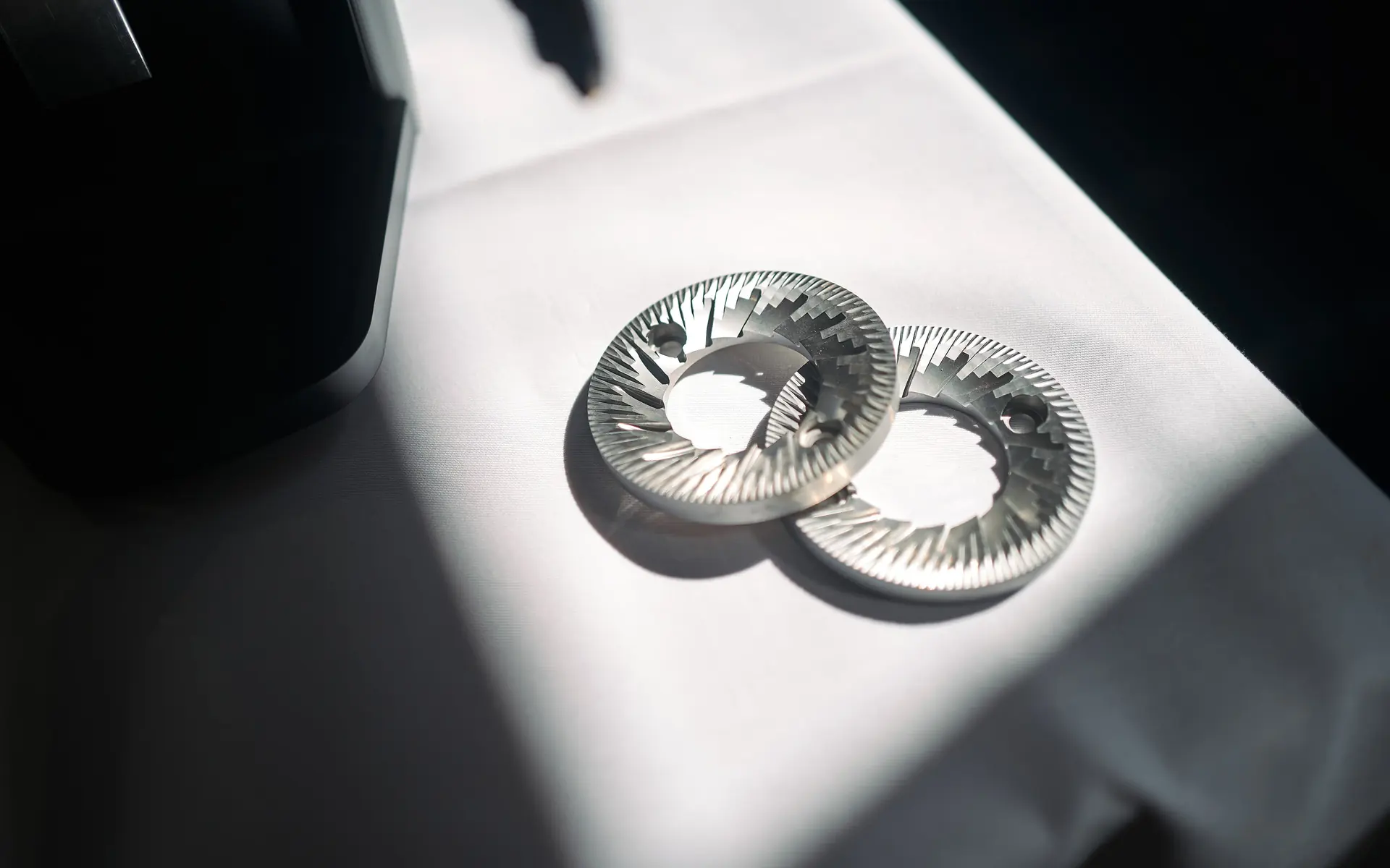 A pair of Mahlkönig steel burrs in the light